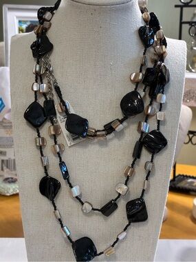 This statement piece is a long, double strand bohemian sweater necklace.